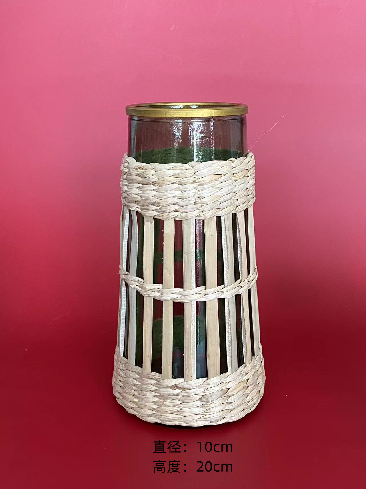 Tall thin conical glass vases surrounded by straw